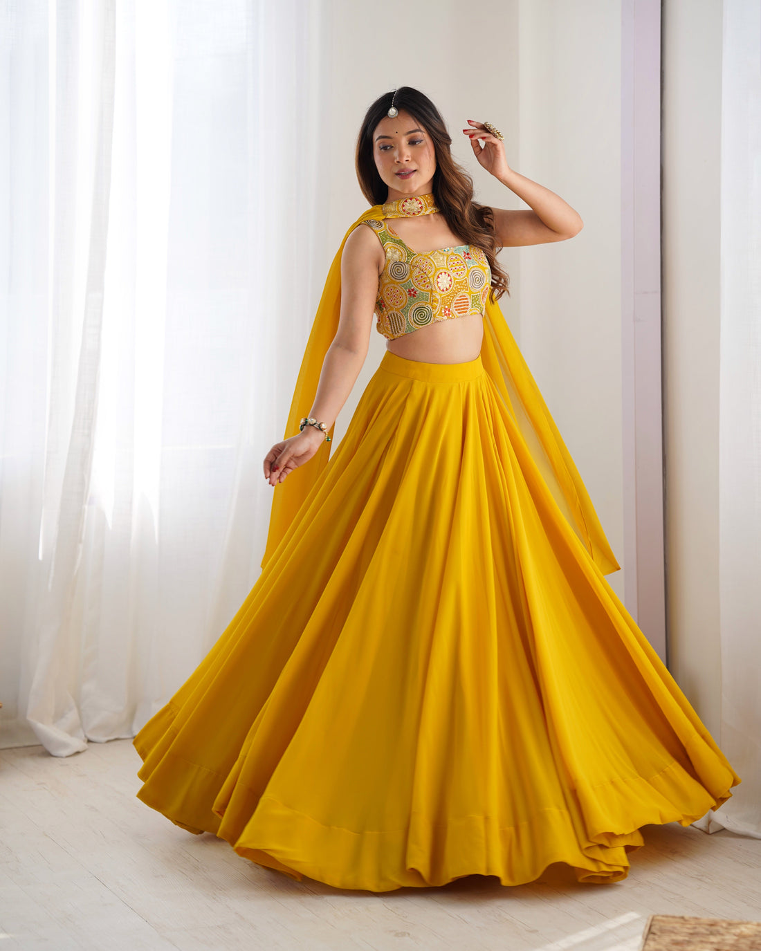 YELLOW COLOR FULLY FLARED LEHENGA CHOLI WITH INTRICATE EMBROIDERY