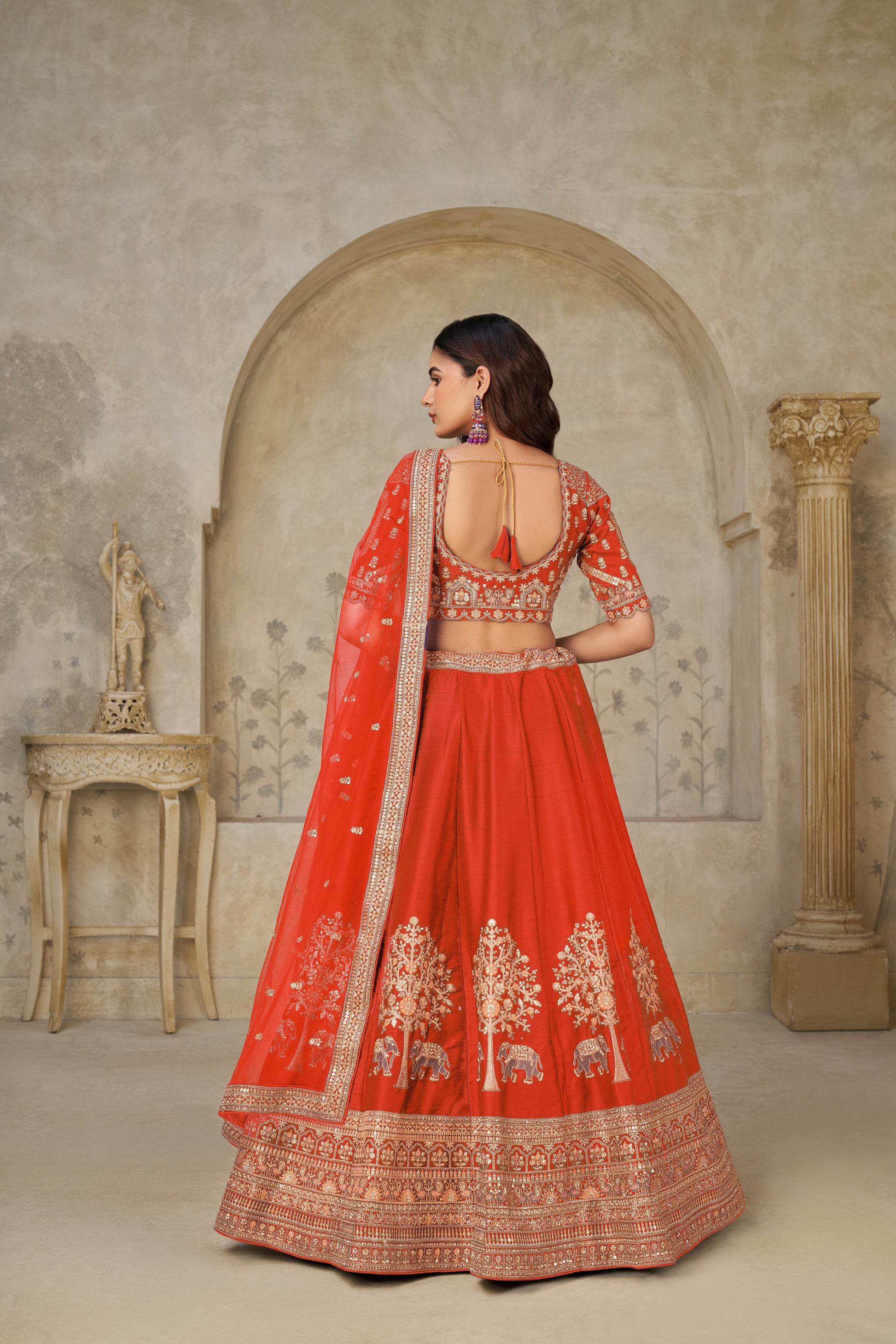 TRENDY RUST WEDDING LEHENGA WITH INTRICATE ELEPHANT MOTIFS