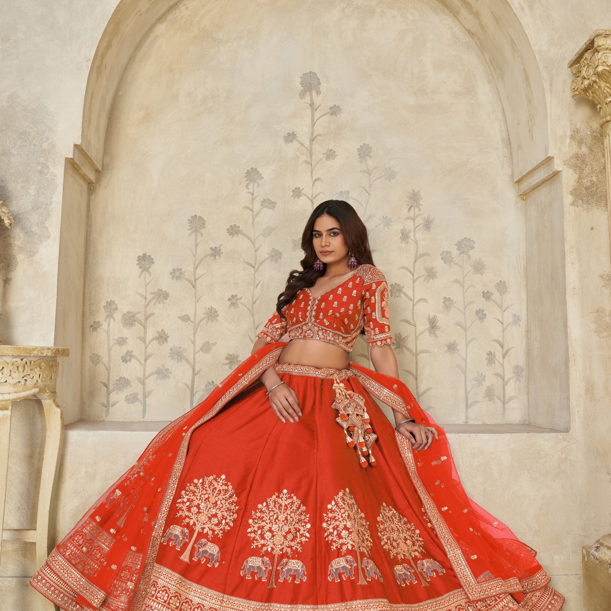 TRENDY RUST WEDDING LEHENGA WITH INTRICATE ELEPHANT MOTIFS