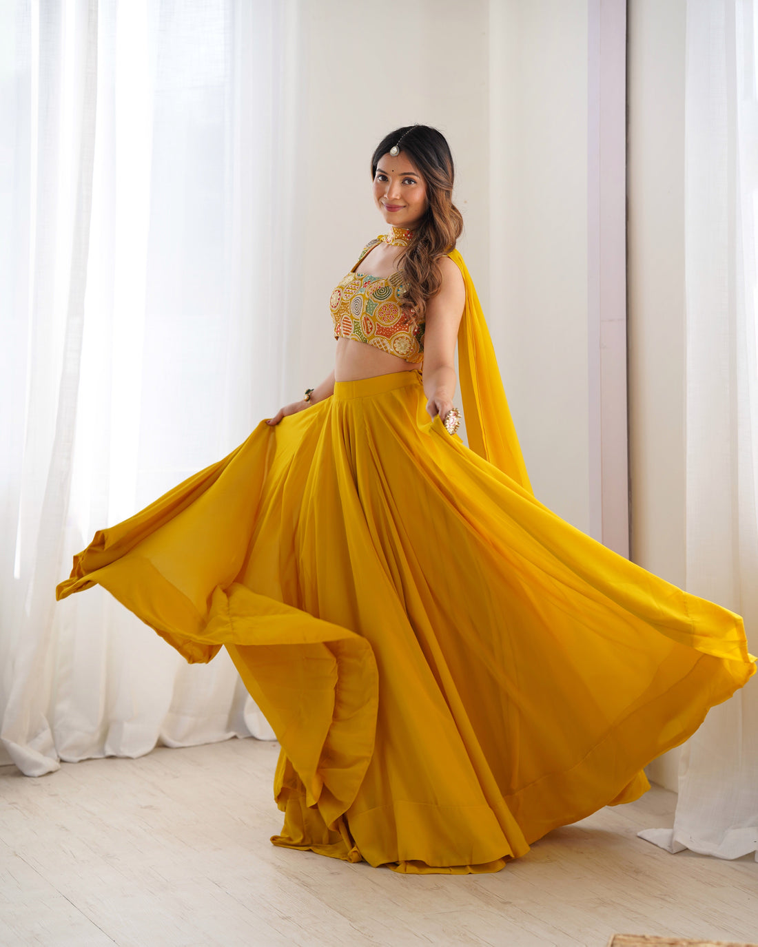 YELLOW COLOR FULLY FLARED LEHENGA CHOLI WITH INTRICATE EMBROIDERY
