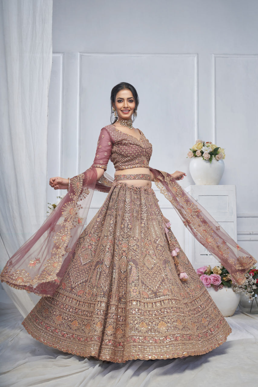 ROYAL GRANDEUR BRIDAL ONION-COLORED SOFT NET LEHENGA WITH PAISLEY & PEACOCK MOTIFS AND HEAVY EMBROIDERY